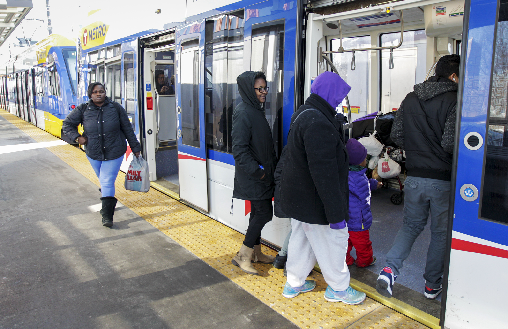 Riders board a Metro Transit Green Line train at the Capitol/Rice Street Station in February 2020. The COVID-19 pandemic is having a big impact on Minnesota's transportation systems, officials told a House committee. House Photography file photo
